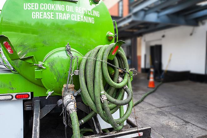 large truck pumping grease trap at a restaurant in Orosi CA